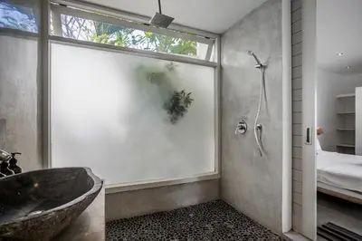 a bathroom with a large window and a tub at Villa Nakal by Alfred in Bali in Seminyak