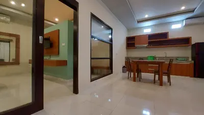 a kitchen and dining room with a table and chairs at The New Moon Seminyak in Seminyak