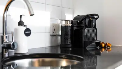 a kitchen counter with a coffee maker and a sink at Villa Opihr in Seminyak