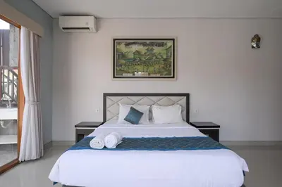 a bedroom with a large white bed with two pillows at Hoki Villa by Urbanview Villa in Kerobokan