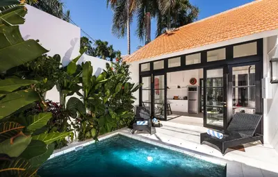 a house with a swimming pool in front of a house at Villa Saffron in Seminyak