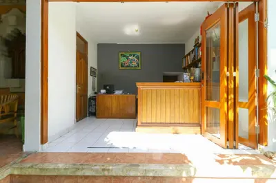 an entrance to a room with a wooden door at The Legian Mas Beach Inn in Kuta
