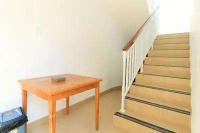 a stairway with a wooden table next to a staircase at Manu Guest House 2 in Canggu