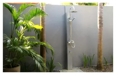 a shower in a bathroom with two palm trees at Premium Villas Seminyak I in Seminyak