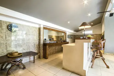 a kitchen with a counter and a table at Premium Villas Seminyak I in Seminyak