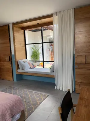 a bedroom with a window with a bed and a table at Villa MOSAIC - Stunning Designed Spacious Villa - Center Canggu in Canggu