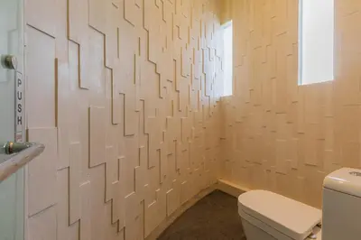 a bathroom with a toilet and a window at Taman Mesari Luxury Villas-Seminyak in Seminyak