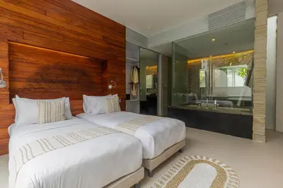 a bedroom with two beds and a large mirror at Taman Mesari Luxury Villas-Seminyak in Seminyak