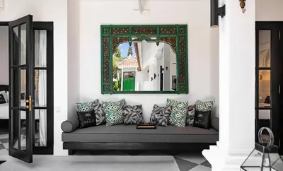 a living room with a couch and a mirror at Villa Nago Walk to Seminyak Best Spots in Seminyak