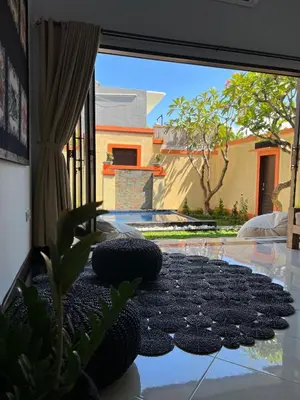 a room with a glass table with a large window at Villa Margherita in Seminyak