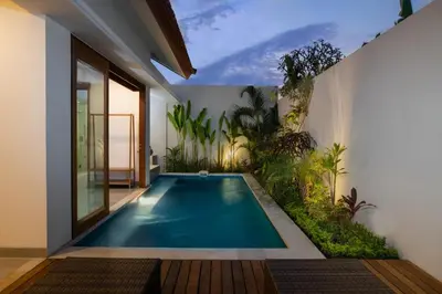 an indoor swimming pool in the middle of a house at Taman Sari Pengubengan Villa in Kerobokan
