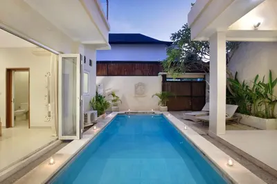 a swimming pool in the middle of a house at Villa Maleena in Seminyak