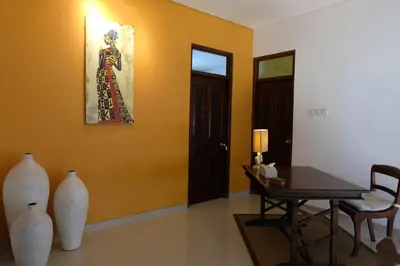 a room with vases and a table and a painting at Villa Celavi 77 in Jimbaran