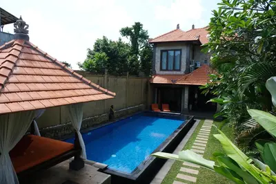 a swimming pool in front of a house at Villa Celavi 77 in Jimbaran