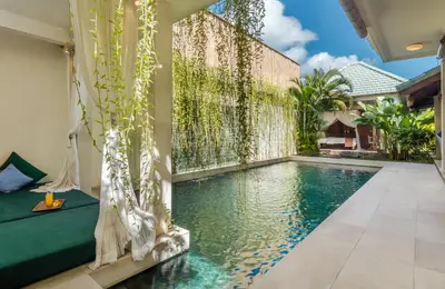 a swimming pool in the middle of a house at Villa Beji in Seminyak