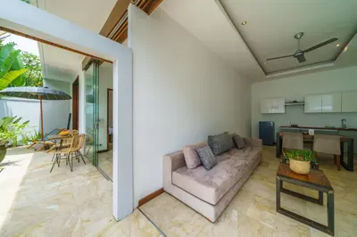 a living room with a couch and a table at Anema Villa Seminyak in Legian