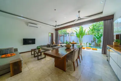 a living room with a table and a couch at Anema Villa Seminyak in Legian