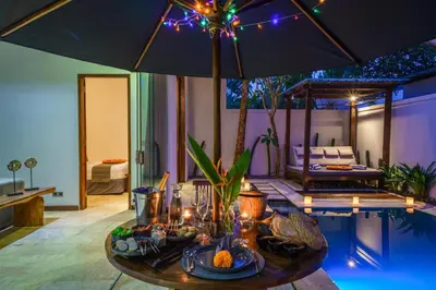a living room with a table with food and an umbrella at Anema Villa Seminyak in Legian