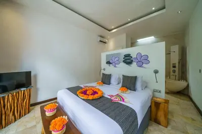 a bedroom with a white bed with a bowl on it at Anema Villa Seminyak in Legian