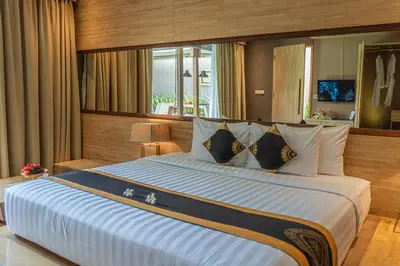 a large bedroom with a large bed with white pillows at Asa Bali Luxury Villas & Spa in Seminyak