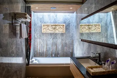 a bathroom with a bath tub and a sink at Asa Bali Luxury Villas & Spa in Seminyak