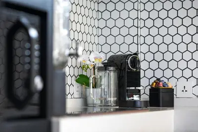 a kitchen counter with a coffee maker on a counter top at Summer House Villa in Canggu