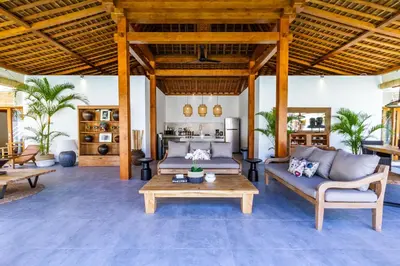 a living room with couches and a table at Villa Hana by Alfred in Bali in Seminyak