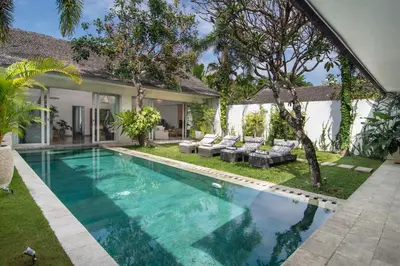 a swimming pool in the backyard of a house at Villa Mia by Villa Finder in Canggu
