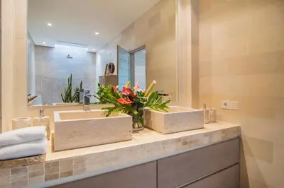 a bathroom with two sinks and a mirror at Villa Mia by Villa Finder in Canggu