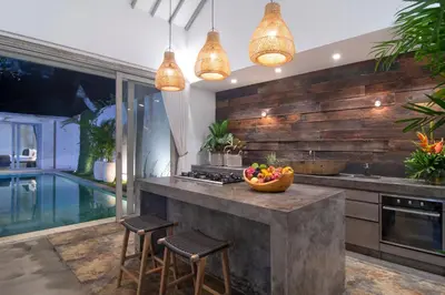 a kitchen with a counter with a bowl of fruit on it at Villa Mia by Villa Finder in Canggu