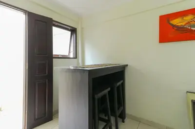 a room with a counter in the corner of a room at Permisol Homestay 88 in Denpasar