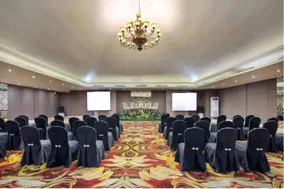 a conference room with chairs and a chandelier at Four Star by Trans Hotel in Sanur