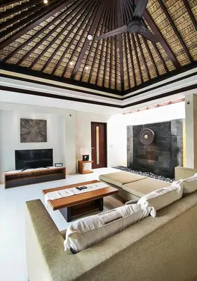 a living room with a couch and a fireplace at Kedonganan Beach Villas in Jimbaran