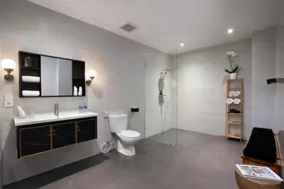 a bathroom with a toilet and a sink and a shower at Huge 11 BR Villa, Sleeps 41, Prime Area, Near Beach in Canggu