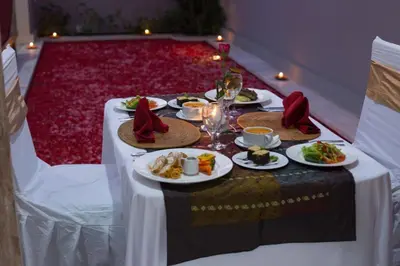 a table with plates of food on top of it at The Awandari Villas Seminyak in Seminyak