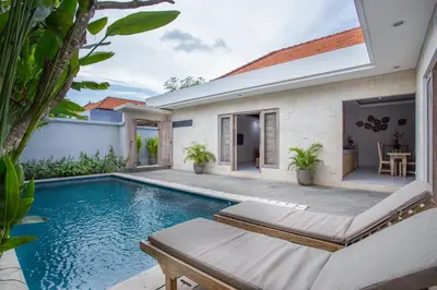 a swimming pool in the backyard of a villa at The Awandari Villas Seminyak in Seminyak