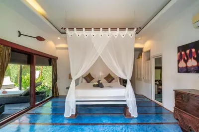a bedroom with a bed with a canopy at Luxury Villa La plancha BEACH 200m, Heart of Seminyak in Seminyak