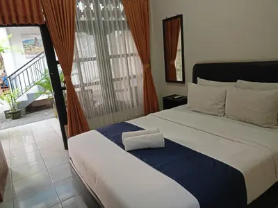 a bedroom with a bed with a towel on it at Catur Adi Putra in Denpasar