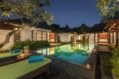 an image of a villa with a swimming pool at night at Villa Litera Seminyak Bali in Seminyak
