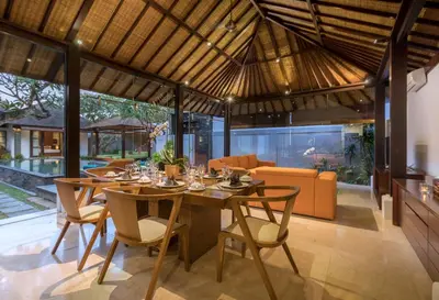 an open dining room with a table and chairs at Villa Litera Seminyak Bali in Seminyak