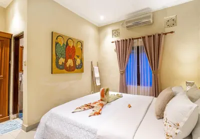 a bedroom with a bed with a stuffed animal on it at Villa Retro 88 in Seminyak