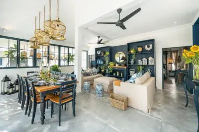 a dining room and living room with a table and chairs at Luxe 5 Bed, Sleeps 10, Butler, Walk to ShopsCafe in Seminyak