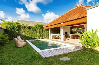 a backyard with a swimming pool and a house at Awesome 1BR Villa in the heart of Seminyak in Seminyak
