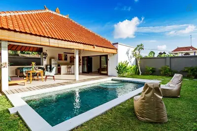 a backyard with a swimming pool and a house at Awesome 1BR Villa in the heart of Seminyak in Seminyak