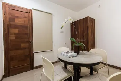 a dining room with a table and chairs and a door at Kuta Legian Villa 3 Bedroom Private pool in Legian