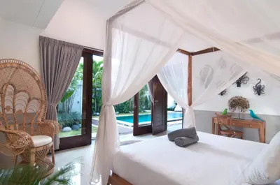 a bedroom with a bed and a chair and a desk at 3BR Villa Olli - Minggu Villas -Special Stay Bonus in Kerobokan