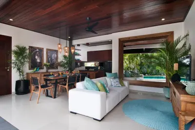 a living room with a white couch and a table at 3BR Villa Olli - Minggu Villas -Special Stay Bonus in Kerobokan
