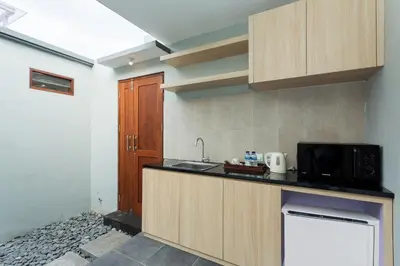 a kitchen with a sink and a microwave at Radea Villa in Kerobokan