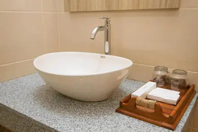 a white bowl on a counter in a bathroom at D Sarian Seminyak in Seminyak