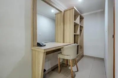 a dressing room with a wooden desk and a chair at D Sarian Seminyak in Seminyak